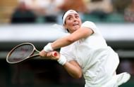 Jabeur plays a backhand at Wimbledon 2023